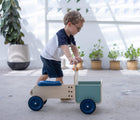 Boy pushing Plan Toys Delivery Bike - Available at www.tenlittle.com