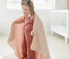 Child using Bloomere Muslin Blanket Cherry - Available at www.tenlittle.com