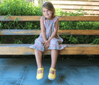 Girl playing in the backyard in Ten Little Canvas Mary Janes in Mellow Yellow