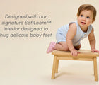Baby on bench wearing Ten Little Everyday Baby Booties designed with signature SoftLoom™ interior designed to hug delicate baby feet - Soft Pink. Available at www.tenlittle.com
