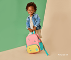 Little Girl Holding Ten Little Recycled Backpack - 12 Inch Pink & Yellow - Available at www.tenlittle.com