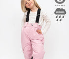 Waterproof and windproof girl wearing Therm Snowrider Convertible Snow Pants - Pink - Available at www.tenlittle.com
