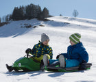 2 Kids playing and riding Kettler - Snow Flyer Sled - Black - Available at www.tenlittle.com