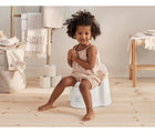 Little Girl Sitting in front view - BabyBjorn Potty Chair - Gray/White - Available at www.tenlittle.com