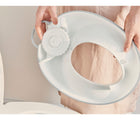 Mom holding back of Baby Holding in a toilet bowl - BabyBjorn Toilet Training Set - White/Gray - Available at www.tenlittle.com