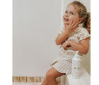 Little Girl Using EllaOla Hydrating Baby Lotion - Available at www.tenlittle.com