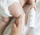 Baby using EllaOla Hydrating Baby Lotion - Available at www.tenlittle.com