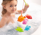 Little girl in a bath tub playing HABA Ocean Fishing Bath Toy - Available at www.tenlittle.com