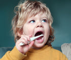 Boy brushing and using Jack N' Jill Natural Toothpaste & Bio Toothbrush - Fluoride Free - Strawberry - Available at www.tenlittle.com