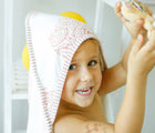 Little boy playing and wearing Malabar Baby Hooded Block Print Towel- Red - Available at www.tenlittle.com