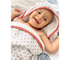 Baby lying and wearing Malabar Baby Hooded Block Print Towel- Red - Available at www.tenlittle.com