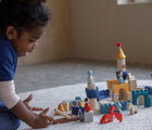 Girl playing Plan Toys Castle Blocks - Available at www.tenlittle.com