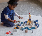 Girl playing Plan Toys Castle Blocks - Available at www.tenlittle.com