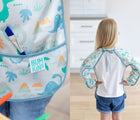 Pocket and closure of Bumkins Dinosaur Long Sleeved Bib. Available from www.tenlittle.com.