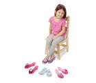Girl sitting and wearing Melissa & Doug Dress up Shoes - Available at www.tenlittle.com