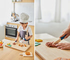 Boy playing the in kitchen and wearing Plan Toys Chef play set - Available at www.tenlittle.com