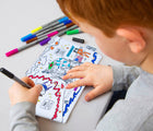 Child coloring in eatsleepdoodle Space Pencil Case Color and Learn. Available from www.tenlittle.com.
