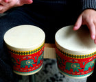 Child playing Djeco Animambo Bongo Drums. Available from www.tenlittle.com.