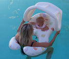 Child and mother floating together in a pool in the Sunnylife Float Together Ring. Available from www.tenlittle.com