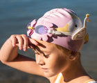 Child wearing the Sunnylife Princess Swan Swim Goggles. Available from www.tenlittle.com