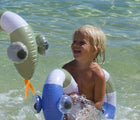 Child playing in the water with the Sunnylife Snake Pool Noodles - Set of 2. Available from www.tenlittle.com