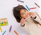 Child holding Honeysticks Natural Beeswax Crayons Jumbos - Set of 12. Available at www.tenlittle.com