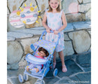 Little girl playing doll inside Adora Color Changing Doll Stroller - Available at www.tenlittle.com