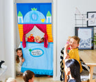 Kids playing with HABA Doorway Puppet Theater - Available at www.tenlittle.com