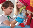 Boy and girl playing HABA Doorway Puppet Theater - Available at www.tenlittle.com