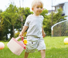 Boy carrying the Hape Picnic Playset - Available at www.tenlittle.com