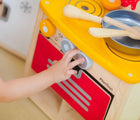 Kid playing with Plan Toys Compact Kitchen Set - Available at www.tenlittle.com