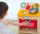 Kid playing with Plan Toys Compact Kitchen Set - Available at www.tenlittle.com