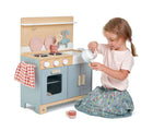 Girl playing with Tender Leaf Home Kitchen with Accessories - Available at www.tenlittle.com