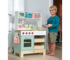 Boy standing beside the Tender Leaf Kitchen Range with Accessories - Available at www.tenlittle.com