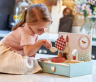 Girl playing with Tender Leaf Kitchenette - Available at www.tenlittle.com