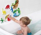 Boy playing with Edushape Dino Bath Foam Toys in the bath. Available from www.tenlittle.com.
