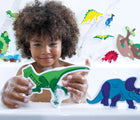 Child playing with Edushape Dino Bath Foam Toys in the bath. Available from www.tenlittle.com.