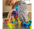 Child playing with Fat Brain Toys Squigz. Available from www.tenlittle.com.