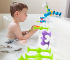 Boy playing with Fat Brain Toys Squigz in the bath. Available from www.tenlittle.com.