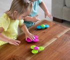 Children playing with Fat Brain Toys Whirly Squigz. Available from www.tenlittle.com.