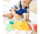 Child playing with Melissa & Doug Soft Taco Fill & Spill. Available from www.tenlittle.com.