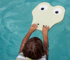 Child swimming in pool with the Sunnylife Crocodile Kickboard. Available from www.tenlittle.com