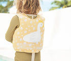 Child wearing the Sunnylife Swan Float Vest. Available from www.tenlittle.com