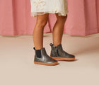 Girl wearing Ten Little Chelsea Boots in Metallic Gray. Available at www.tenlittle.com