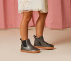 Girl wearing Ten Little Chelsea Boots in Metallic Gray. Available at www.tenlittle.com