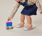 Baby playing and wearing TenLittle-First-Walker Rose Pink - Available at www.tenlittle.com