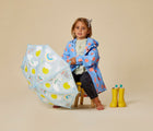 Child holding the Floss & Rock Color Changing Umbrella - Suns & Clouds. Available from www.tenlittle.com