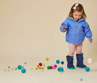 Baby wearing Ten Little Snow Bootsin Navy and Teal. Available at www.tenlittle.com