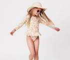 Child wearing the Snapper Rock One piece UPF 50+ Swimsuit - Hawaiian Luau. Available from www.tenlittle.com