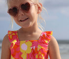 Closeup of child wearing the Snapper Rock UPF 50+ Swim Shorts - Flowers. Available from www.tenlittle.com